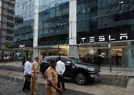 Police direct traffic outside the Tesla showroom ahead of its opening in Mumbai