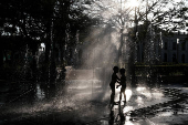 Children play at a fountain in San Salvador