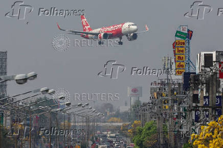 FILE PHOTO: An AirAsia plane prepares to land amid air pollution in Chiangmai province