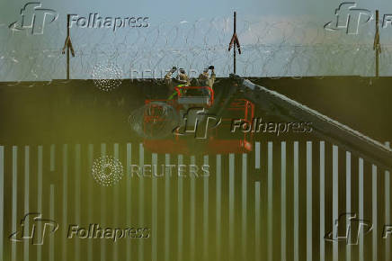 U.S. soldiers reinforce border wall with razor wire seen from Ciudad Juarez