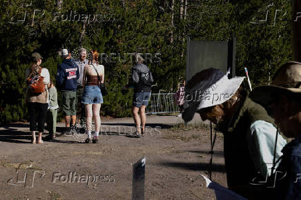 National Park Service Seasonal Interpretation Ranger Steve Northup speaks with visitors arriving at the Madison Information Station in Yellowstone National Park
