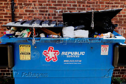 Trash is piled in a dumpster in Watertown