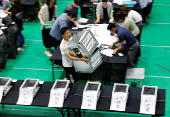 An election official transports empty ballot boxes during Japan's upper house election at a counting centre in Tokyo