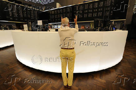 FILE PHOTO: Share traders talk to each other on the trading floor of the trading floor of the German stock exchange in Frankfurt
