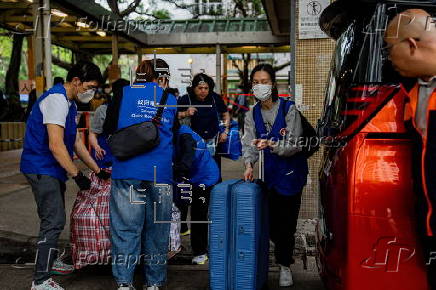 Hong Kong residents affected by the fire gather their belongings from their apartments