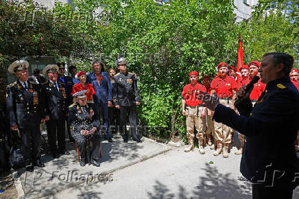 World War Two veteran Nikolai Golubtsov receives congratulations on the upcoming Victory Day in Sevastopol