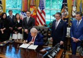 U.S. President Donald Trump signs executive orders at the White House in Washington