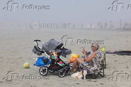People enjoy the beach in England