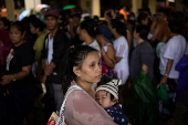 Residents affected by monsoon rains queue for relief following monsoon rains in Quezon City