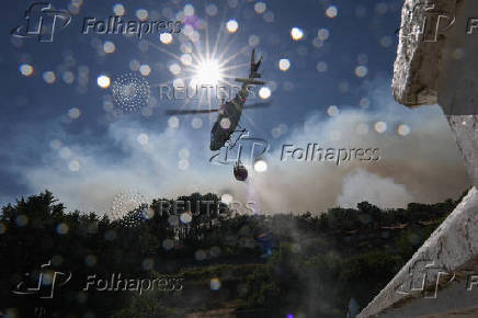 Firefighters battle a wildfire raging in Spain's Avila region
