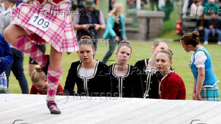 Dancers watch other competitors during the Braemar Royal Highland Gathering at the Princess Royal and Duke of Fife Memorial Park in Braemar, Scotland