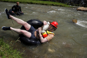Sports enthusiasts compete while floating on inner tyre tubes during the tyre festival 'Bunar Fest' in Prizren