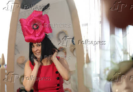 Milliner Merve Bayindir wears one of her hat creations as she speaks to Reuters ahead of the Ascot horse racing festival, in London