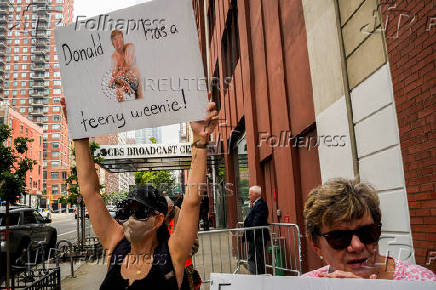 People take part in a protest in front of the CBS broadcast center in New York