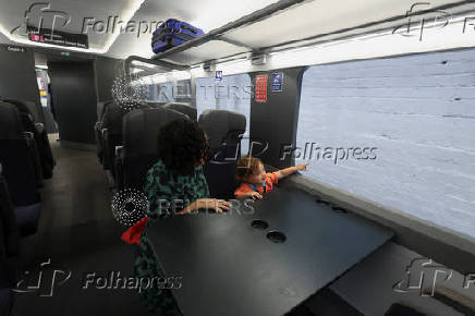 Visitors sit in a life-size mock-up of the Class 895 carriage, part of the new HS2 high-speed train fleet, at The Greatest Gathering, in Derby