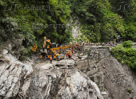 A drone view of BRO and SDRF officials attempting to build a makeshift bridge in Gangnani