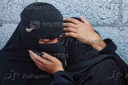 Mourners react during the funeral of Palestinians killed by Israeli fire while trying to receive aid, in Khan Younis