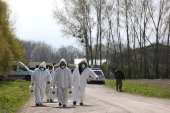 Members of the epidemic authorities carry disinfectant liquid near a farm during the outbreak of foot-and-mouth disease in Dunakiliti