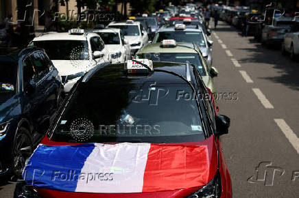French taxi drivers protest near the Bercy Economy and Finance Ministry in Paris
