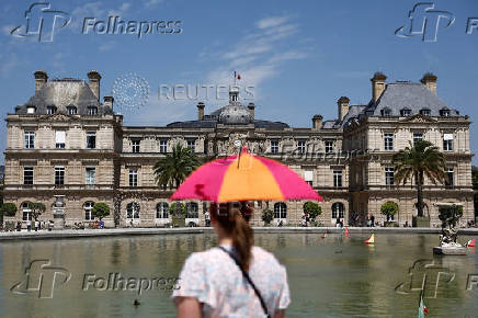 A woman walks in the Jardin du Luxembourg near the French Senate in Paris