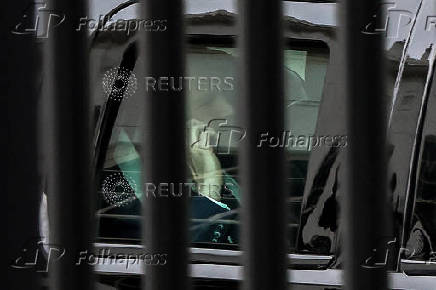 U.S. Vice President J.D. Vance speaks on the phone as his motorcade departs the White House in Washington