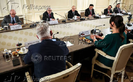 Russian President Vladimir Putin meets with heads of international news agencies in Saint Petersburg