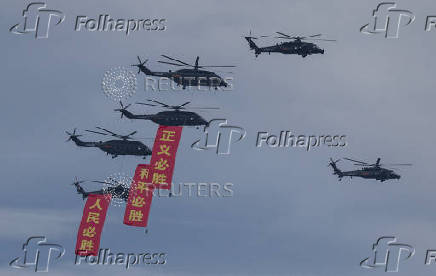 FILE PHOTO: Chinese Z-8L and Z-20 helicopters fly in formation during a flypast rehearsal ahead of military parade to mark the 80th anniversary of the end of World War Two, in Beijing