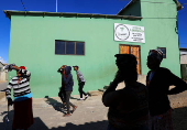 People gather outside the Fellowship Baptist Church, where U.S. pastor Josh Sullivan was kidnapped, in Gqeberha