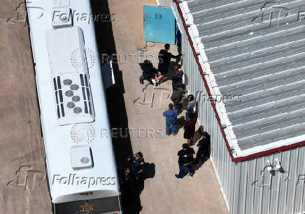 Detainees are escorted off of a bus at the Bluebonnet Detention Facility, in Anson