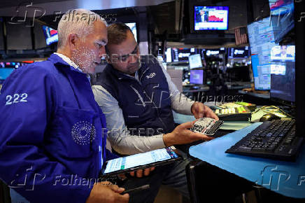 Traders work on the floor of the NYSE in New York
