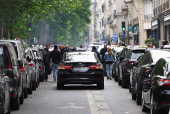 French taxi drivers gather for a strike protesting over proposed government cuts to cash for ferrying patients to and from medical appointments, in Paris