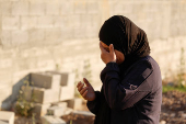 Palestinians visit graves of their relatives at a cemetery in Jenin camp