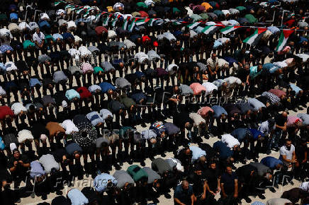 People pray on the day of the funerals of Sayfollah Kamel Musallet and Mohammad Al-Shalabi near Ramallah