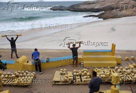 People work out on the Arpoador beach amid strong winds in Rio de Janeiro
