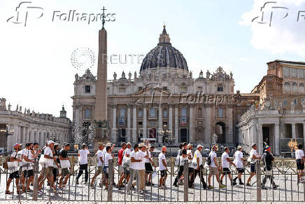 LGBTQ+ pilgrims walk towards St. Peter's Basilica